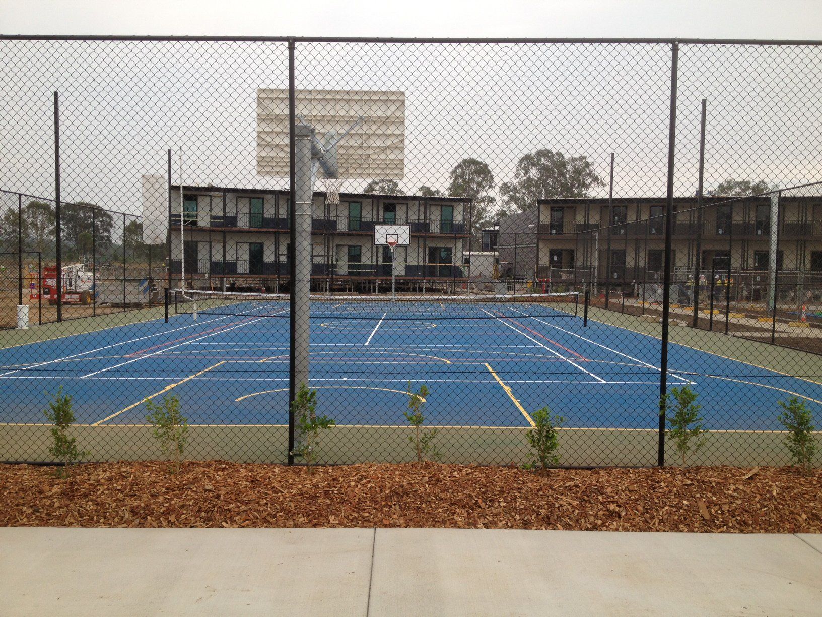 Tennis Court Behind a Fence — Queensland, Australia — Jordin Sports Constructions
