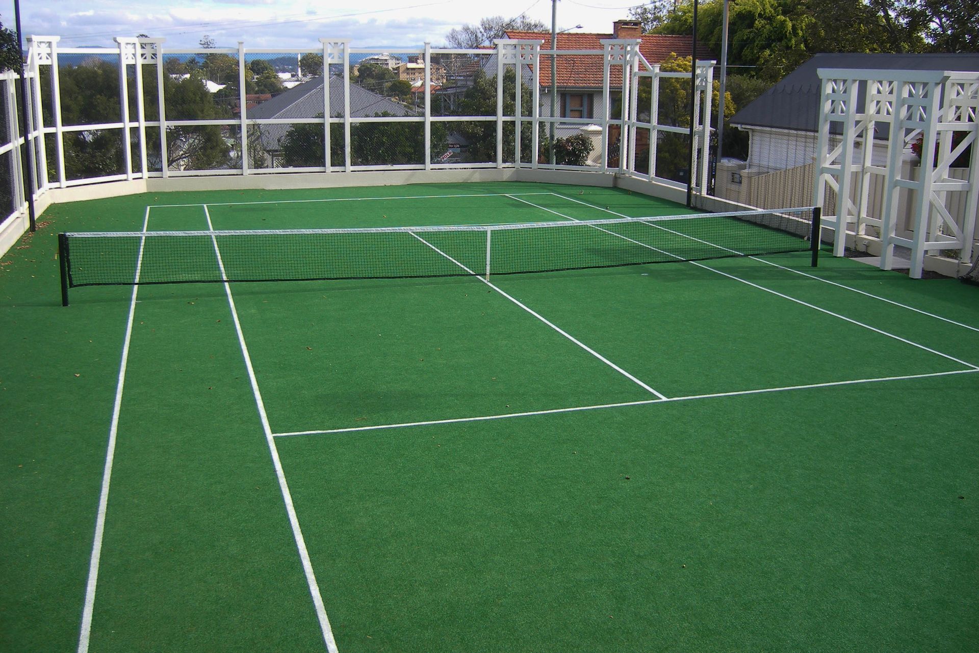 Green Tennis Court with Lines and a Net — Queensland, Australia — Jordin Sports Constructions