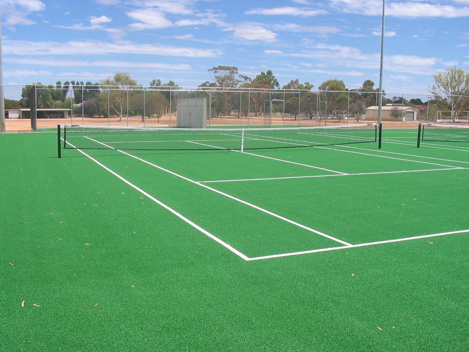 A Tennis Court with Green Grass and White Lines — Queensland, Australia — Jordin Sports Constructions