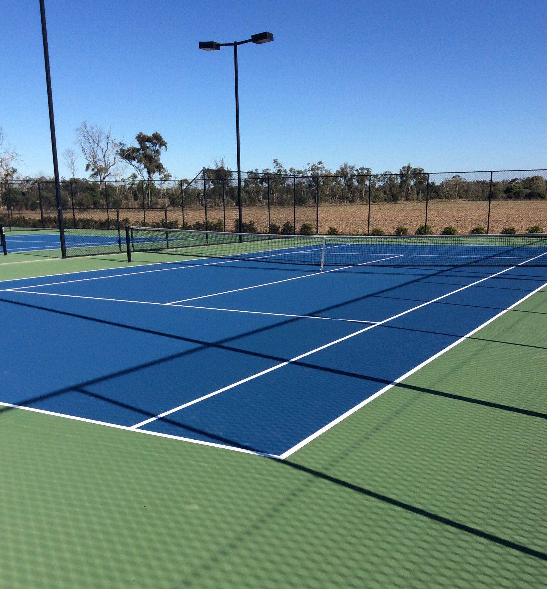 A Tennis Court with a Blue and Green Court — Queensland, Australia — Jordin Sports Constructions