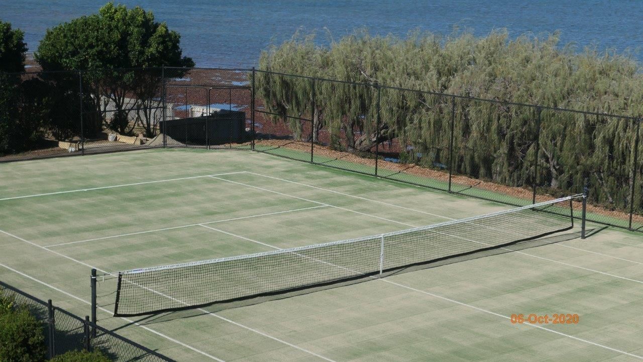 Tennis Court Surrounded by Trees and a Fence — Queensland, Australia — Jordin Sports Constructions