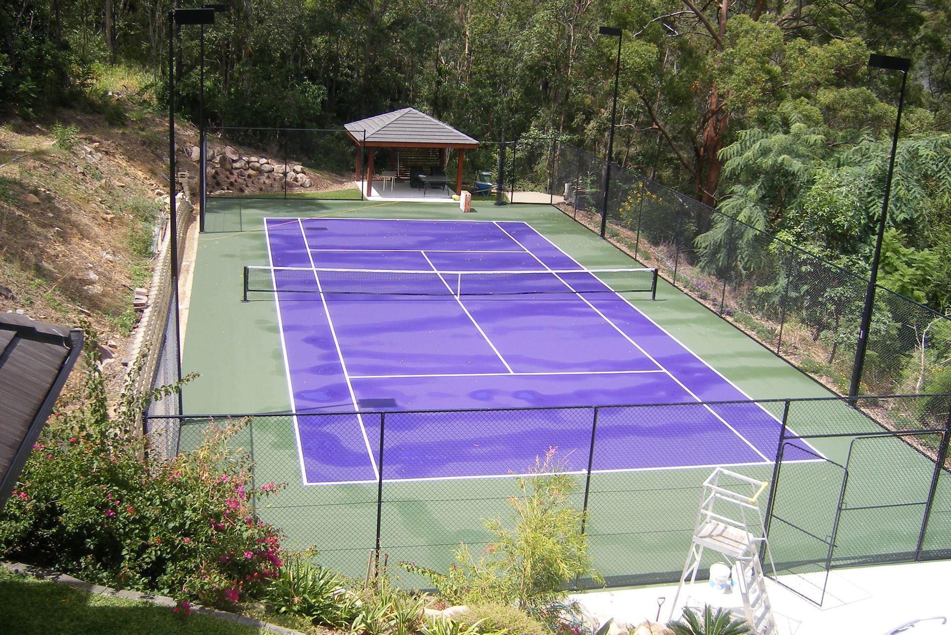 Purple and Green Tennis Court with a Fence Around It — Queensland, Australia — Jordin Sports Constructions