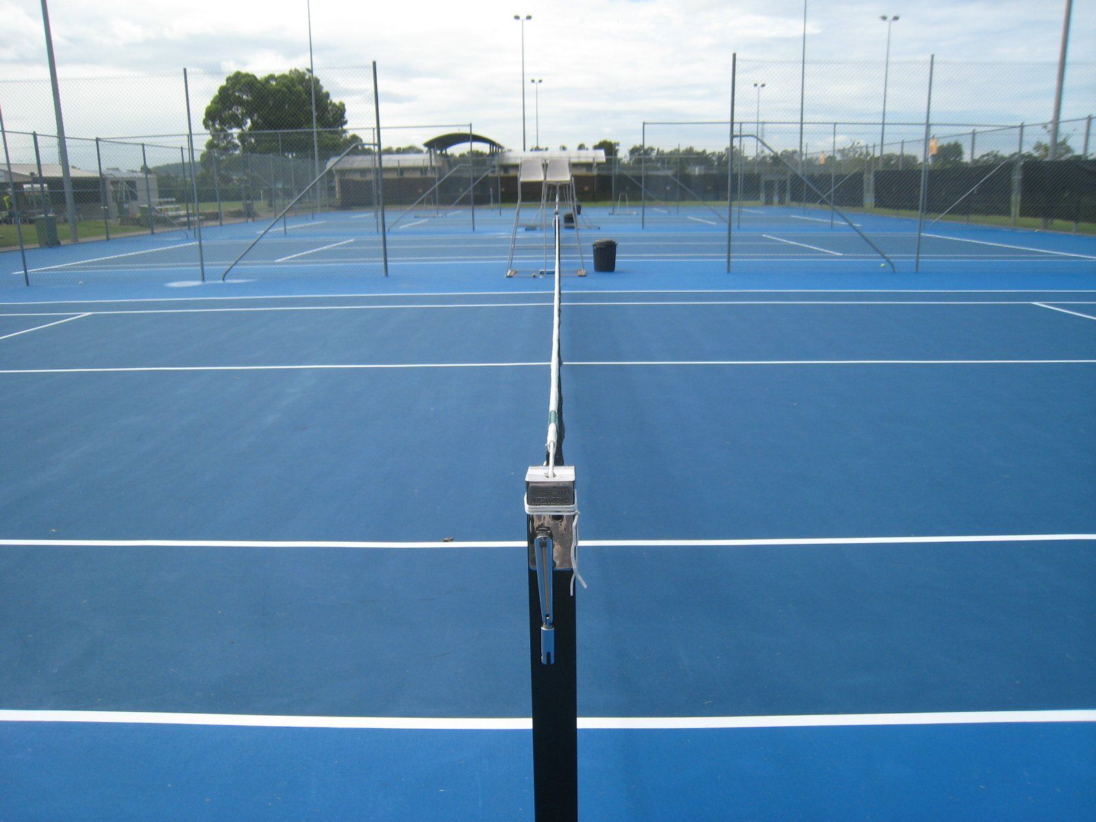 A Blue Tennis Court with White Lines and a Net — Queensland, Australia — Jordin Sports Constructions