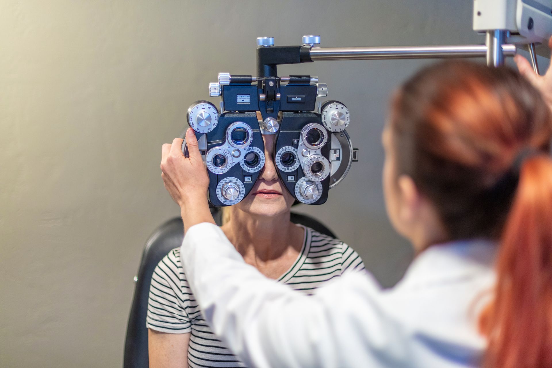 Eye care professional using eye technology equipment. Eye care professional using eye technology equipment.