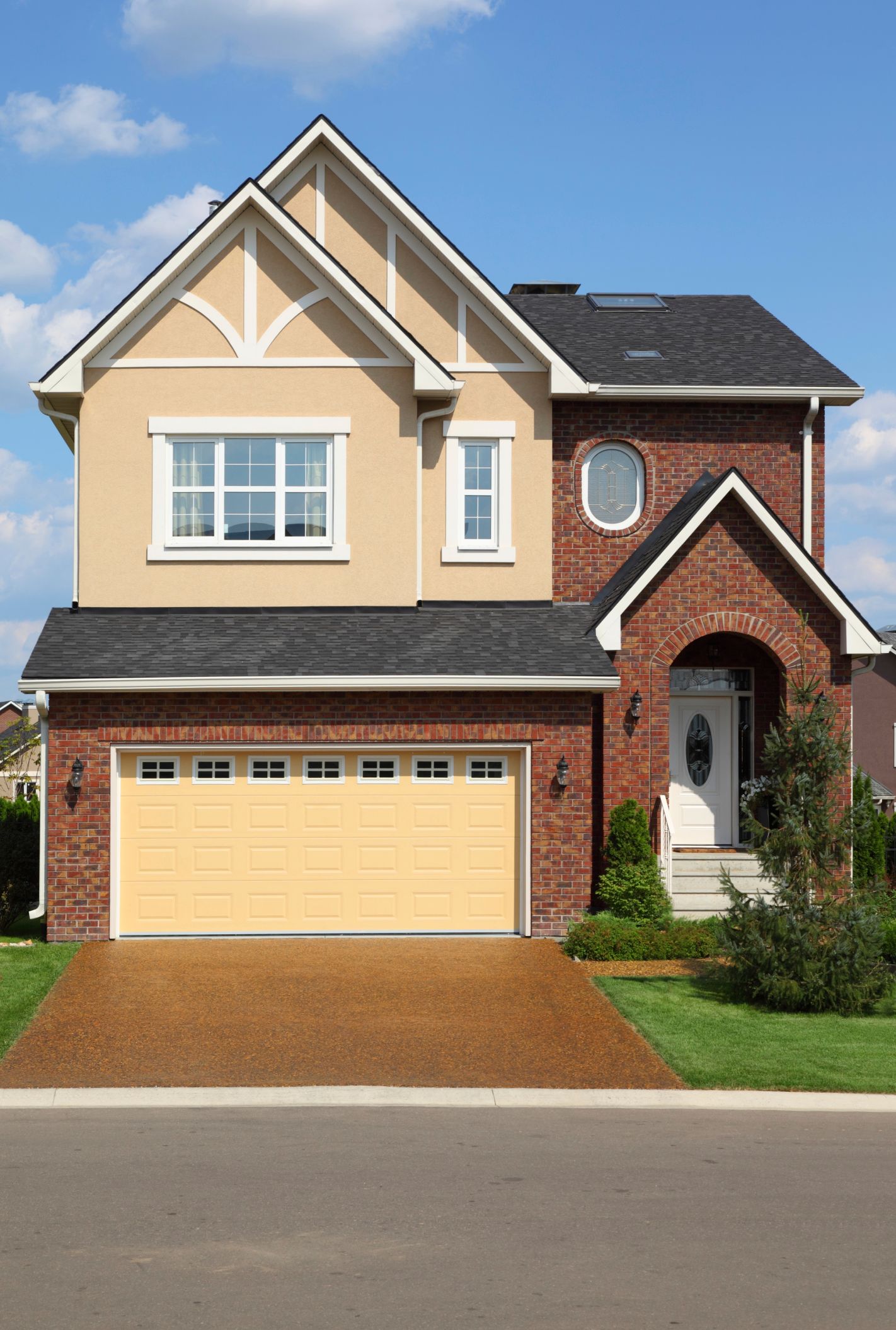 A large house with a yellow garage door