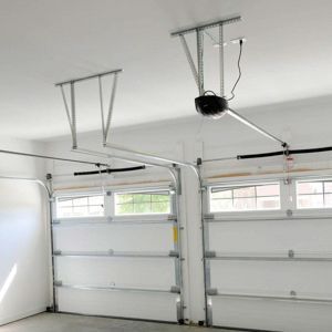 Garage interior with white garage doors and an electric opener attached to the ceiling.