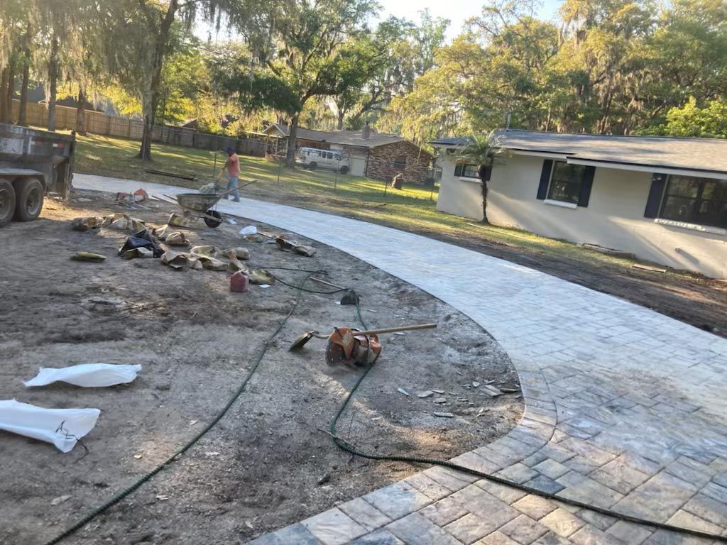 Man Cleaning Up After Paver Installation — Jacksonville, FL