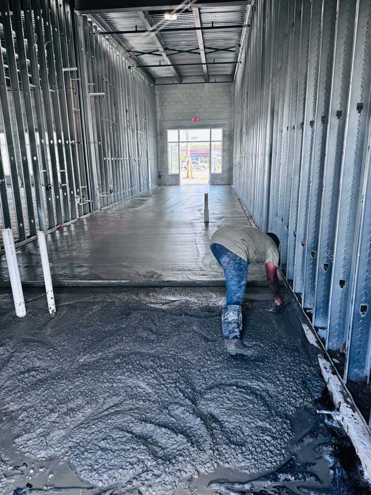Man Leveling Concrete On A Commercial Building in Jacksonville, FL