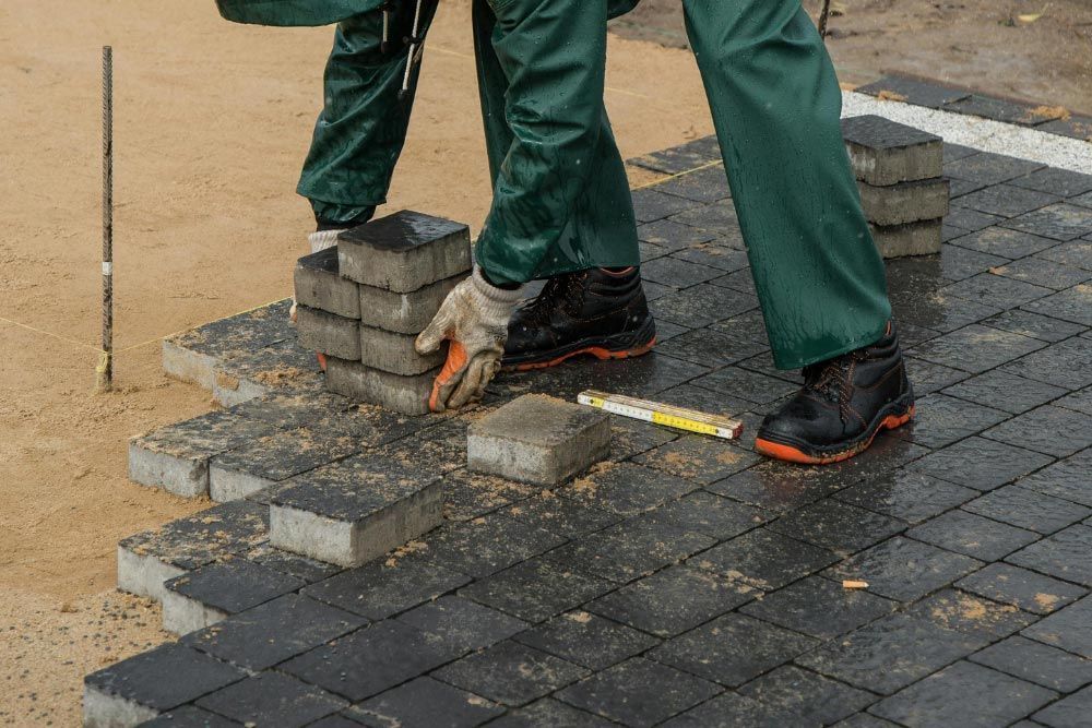 Man Moving Pavers For Installation in Jacksonville, FL