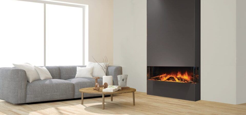 Modern living room with gray sofa, coffee table, and a lit built-in fireplace beside a large window