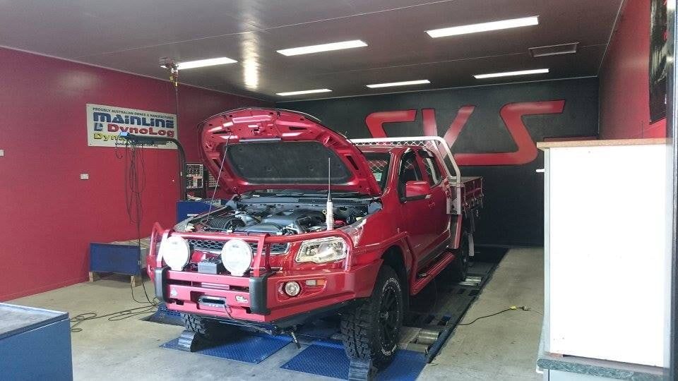 A Red Truck is Parked in a Garage With Its Hood Open — SVS Auto Repairs & Dyno Tuning in Weipa, QLD