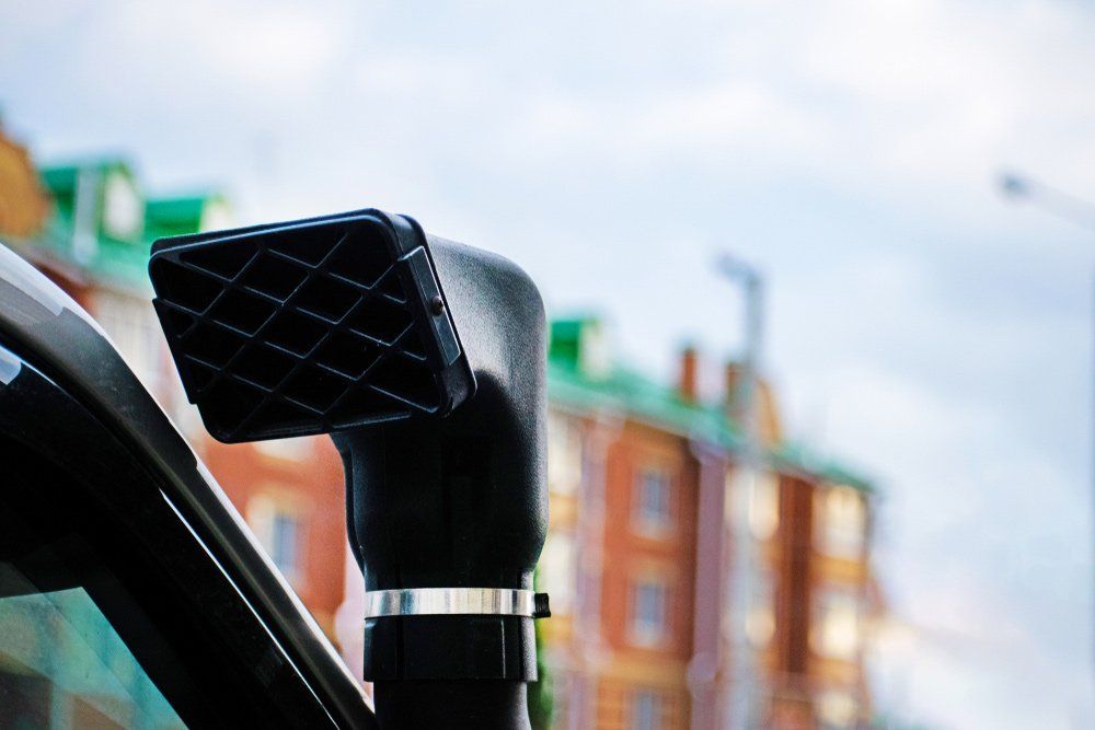 A Car With a Snorkel on the Side of It is Parked in Front of a Building — SVS Auto Repairs & Dyno Tuning in Cairns, QLD