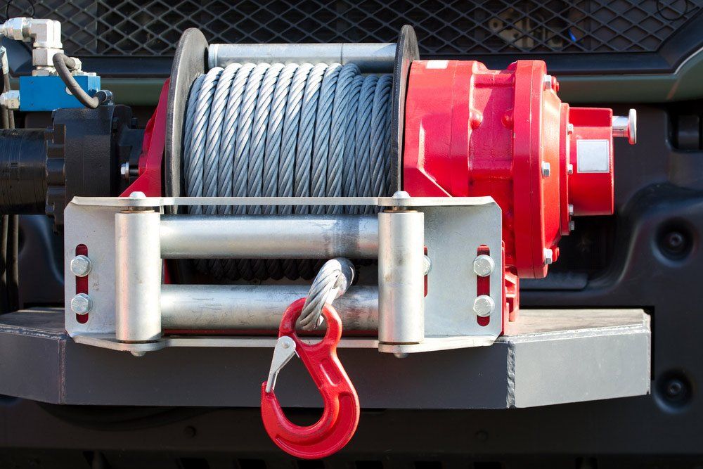 A Red Winch is Attached to the Front of a Truck — SVS Auto Repairs & Dyno Tuning in Weipa, QLD