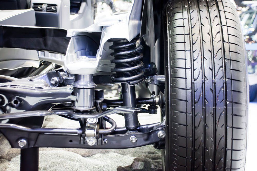 A Close Up of a Car Suspension With a Tire in the Background — SVS Auto Repairs & Dyno Tuning in Bungalow, QLD