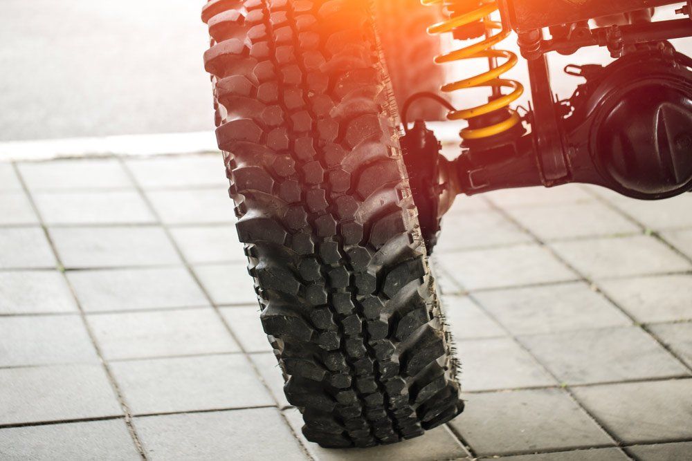 A Close Up of a Tire and Shock Absorber on a Car — SVS Auto Repairs & Dyno Tuning in Weipa, QLD