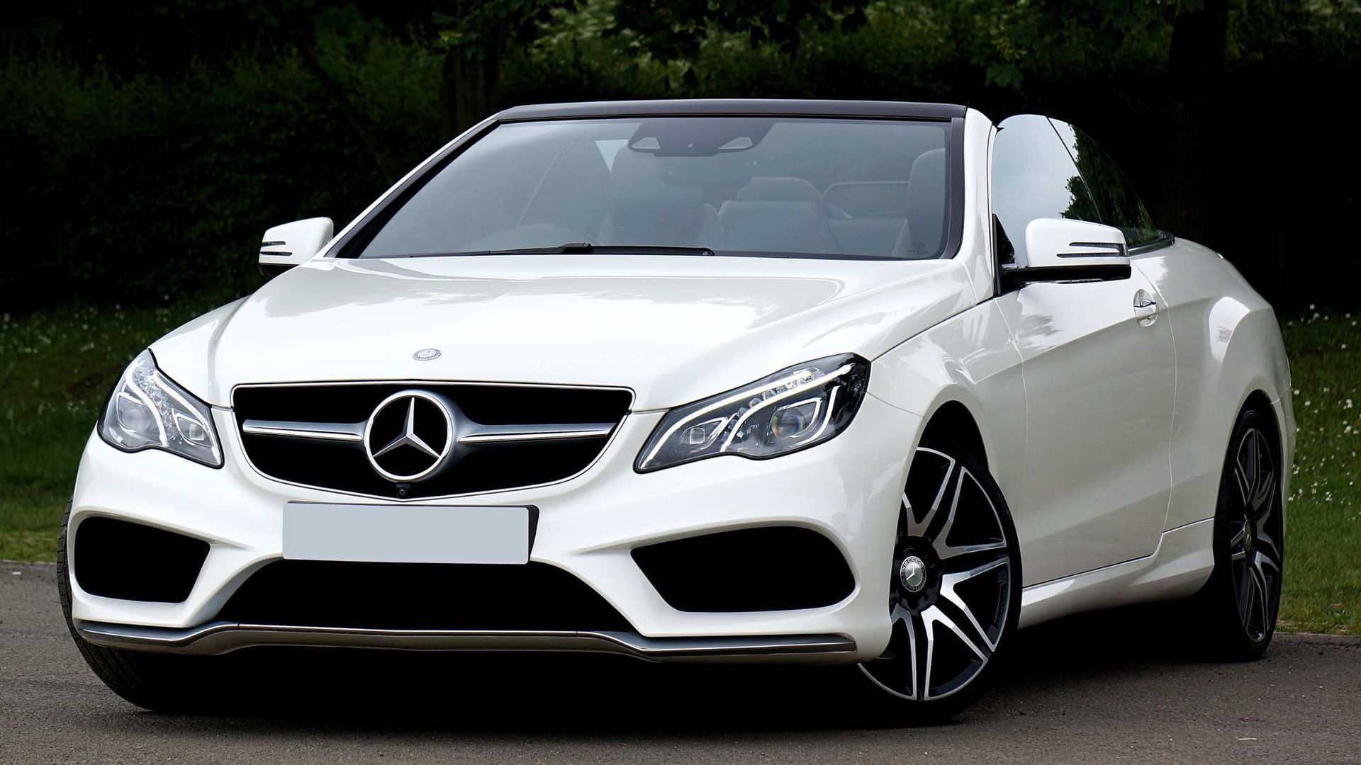 White Mercedes-Benz convertible parked on a road, front view