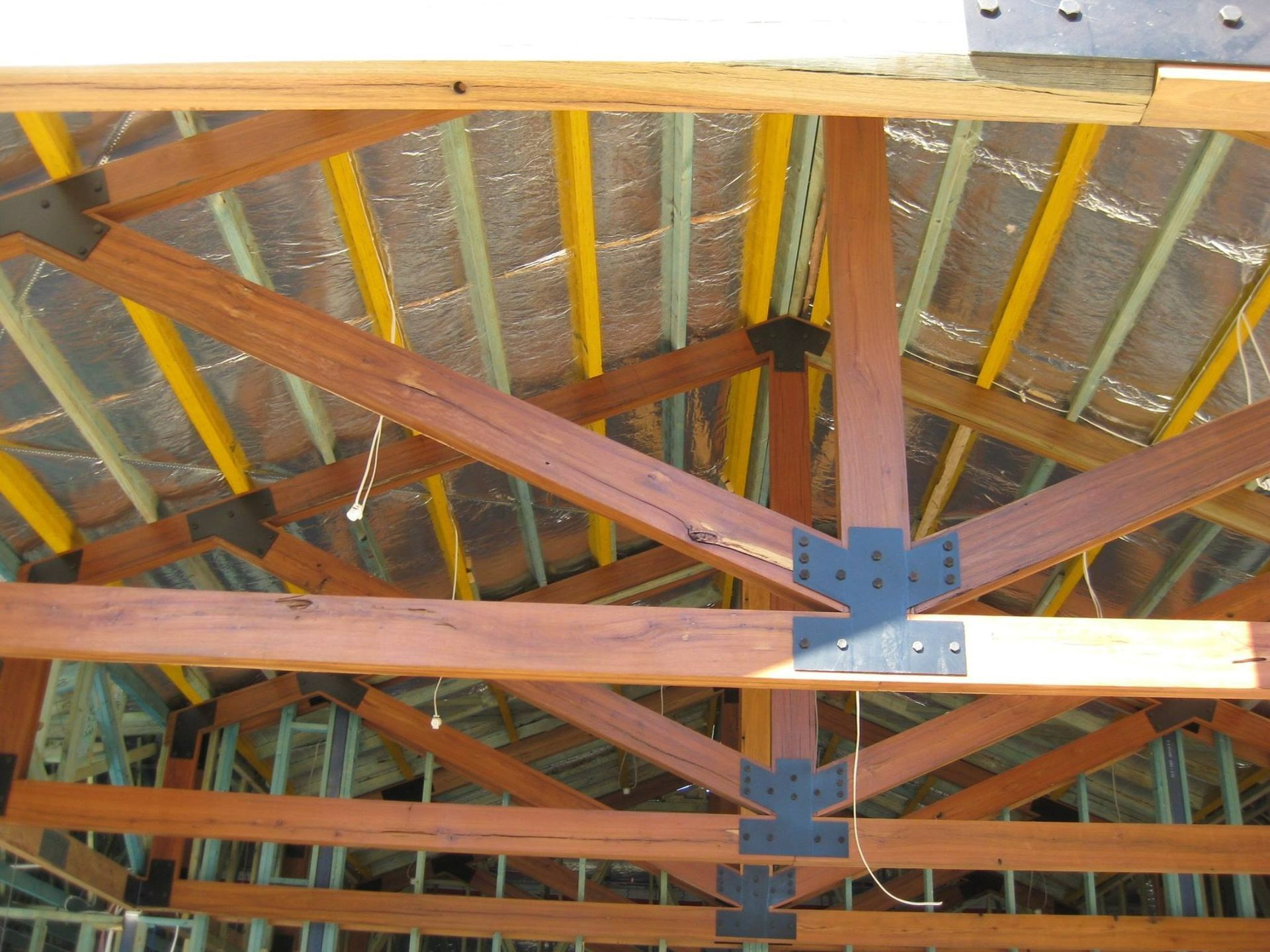 The Ceiling Of A Building Under Construction With Wooden Beams — Hitek Frame & Truss In Forbes, NSW