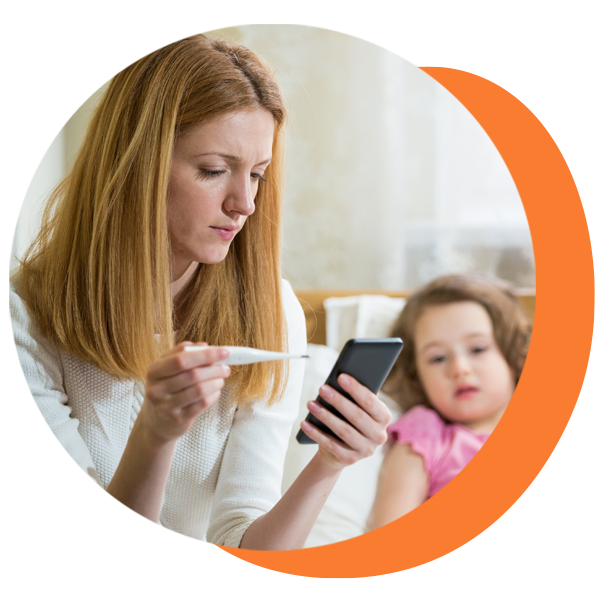 A woman is holding a thermometer and looking at her phone