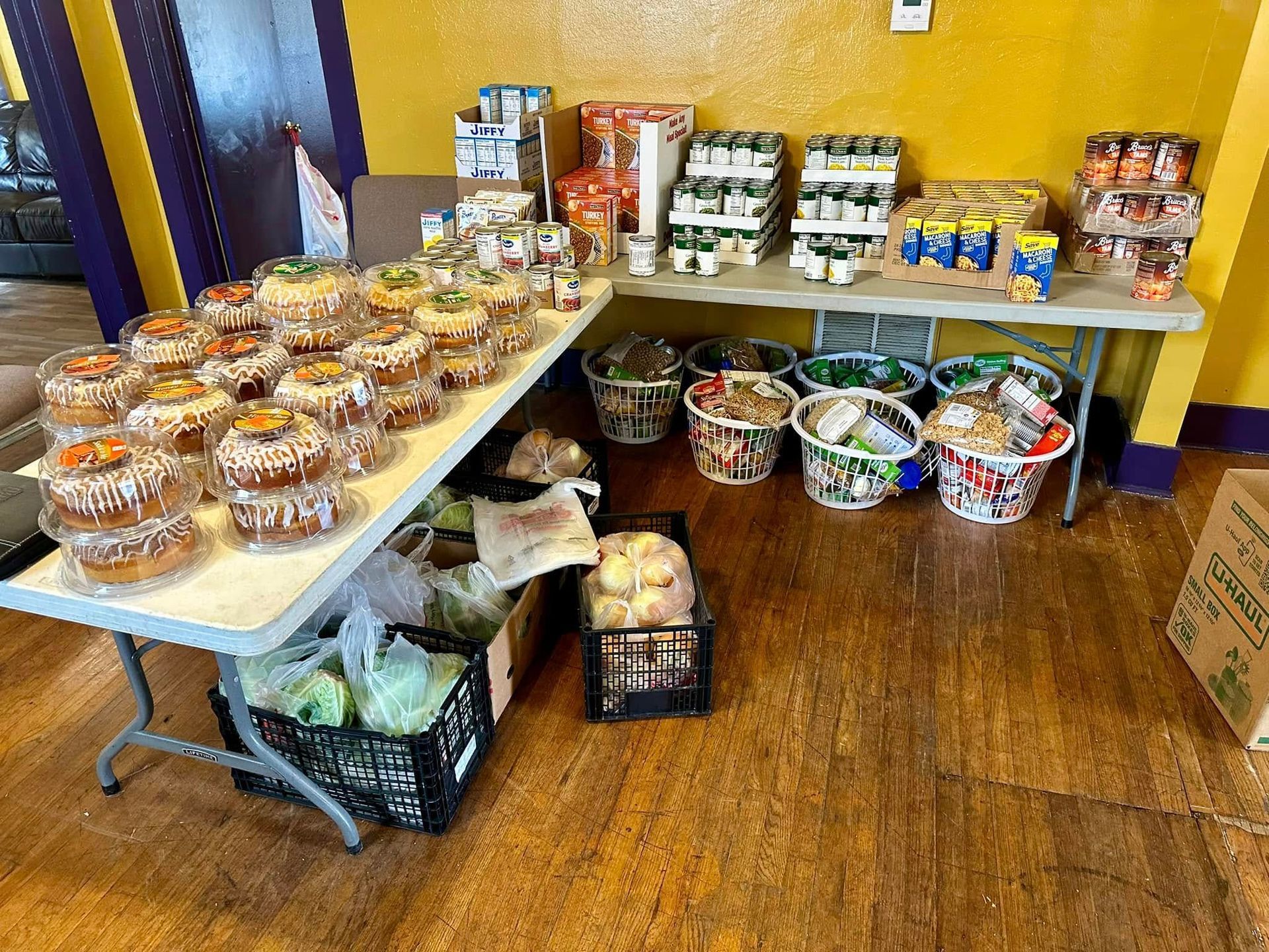 Food items arranged on tables and in baskets. Various canned goods and baked goods are visible.