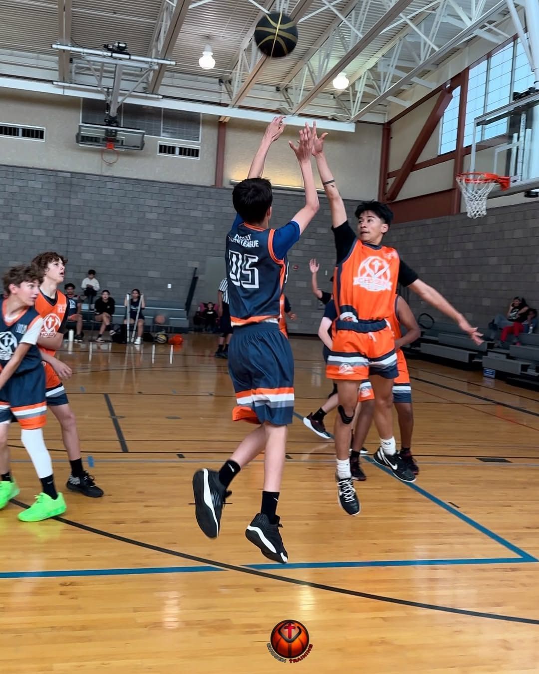 Baseball player sliding into home plate, catcher in front. Blue and gold uniforms, action shot.