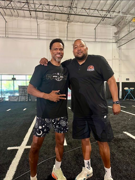 Baseball balls resting on green grass.