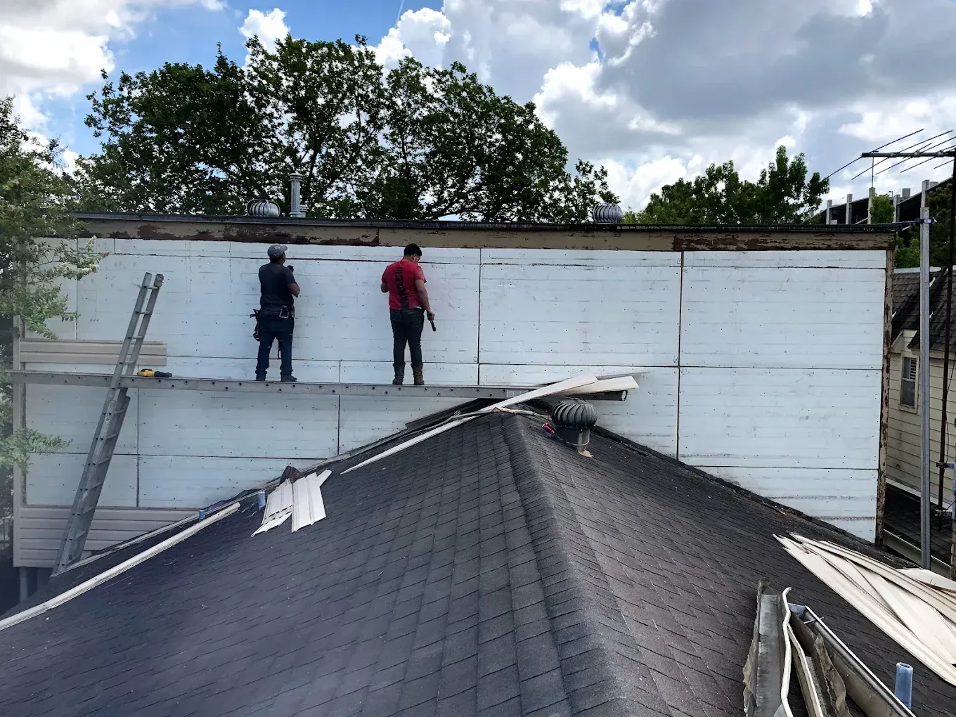 Two workers on a white wall