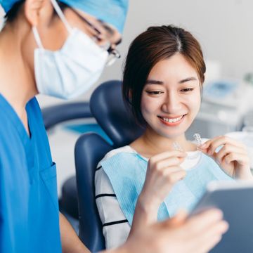 Dentist cleaning patient teeth