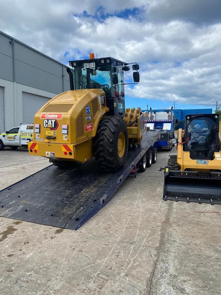 Loading Heavy CAT Loader on a Tow Truck — Port Macquarie Tilt Tray Towing in Kempsey, NSW