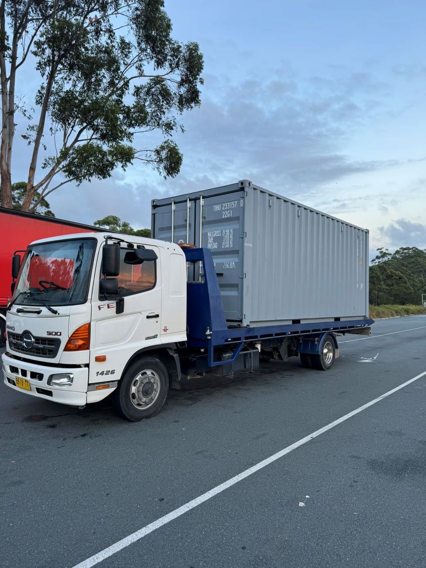 A Tow Truck With a Container on the Back — Port Macquarie Tilt Tray Towing in Kempsey, NSW