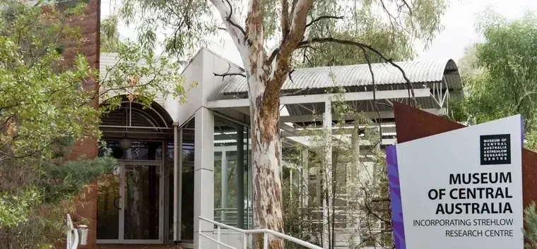 A sign for the museum of central australia is in front of a building.