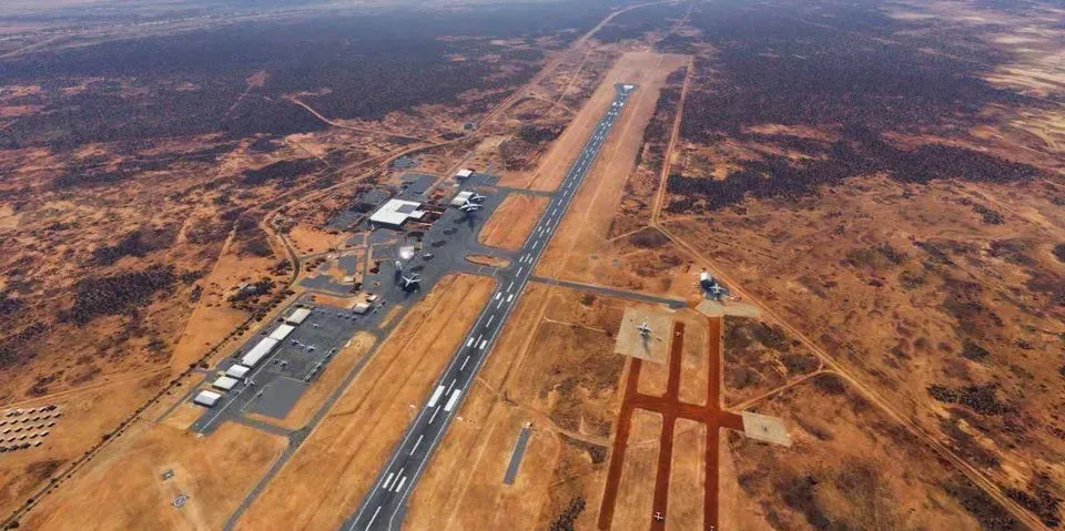 An aerial view of an airport runway in the desert.
