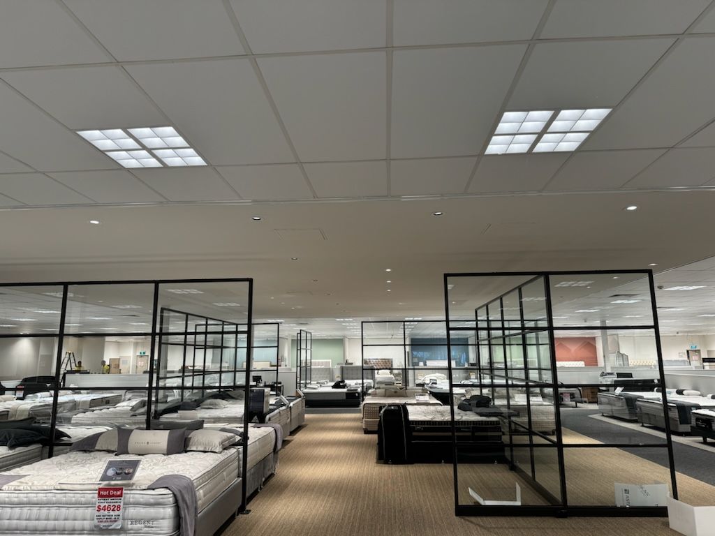 A large room filled with mattresses and furniture