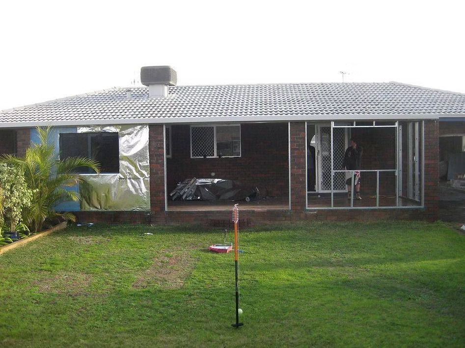 A house with a large lawn in front of it.