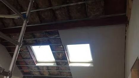 There are two skylights in the ceiling of a building.