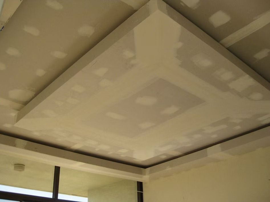 A room with a ceiling that has a lot of holes in it