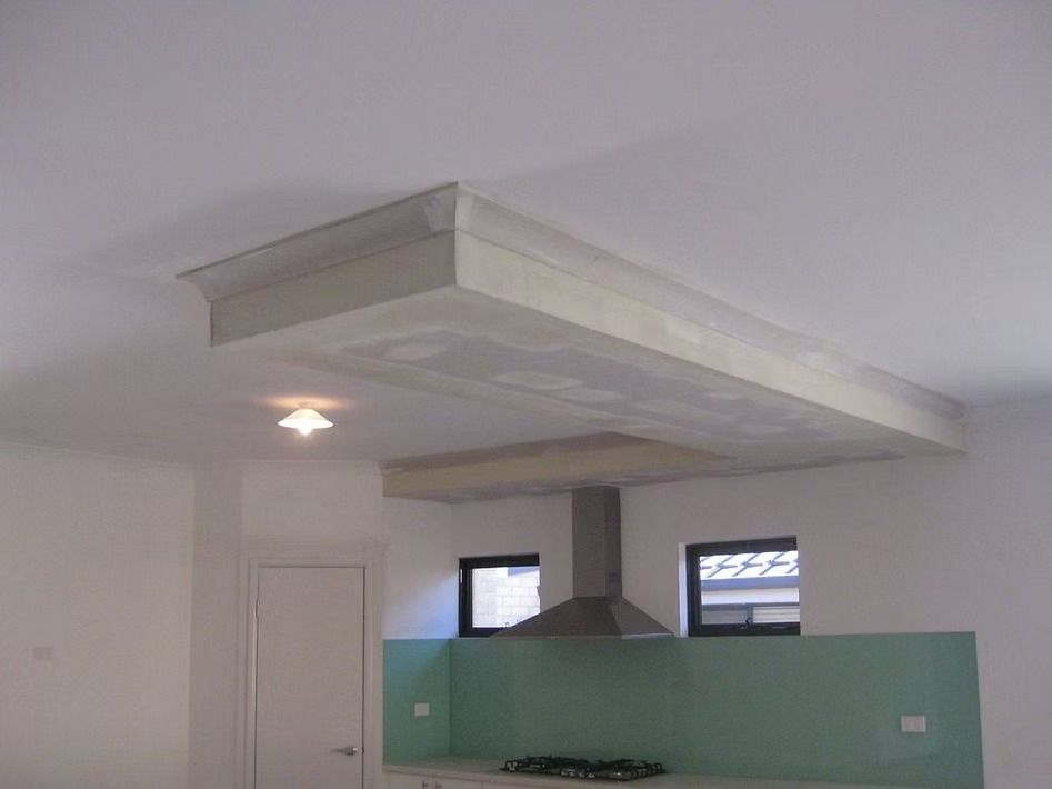 A kitchen with a stove top oven and a ceiling fan