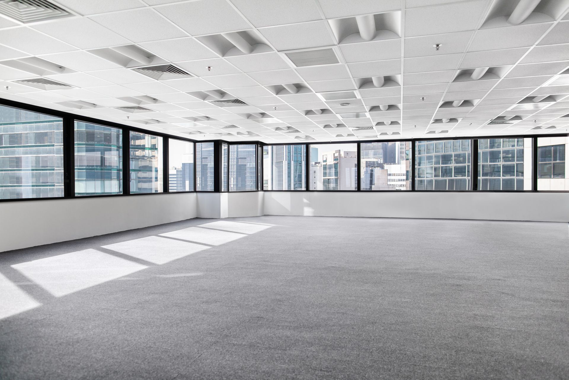 Empty business office interior space with commercial ceiling.