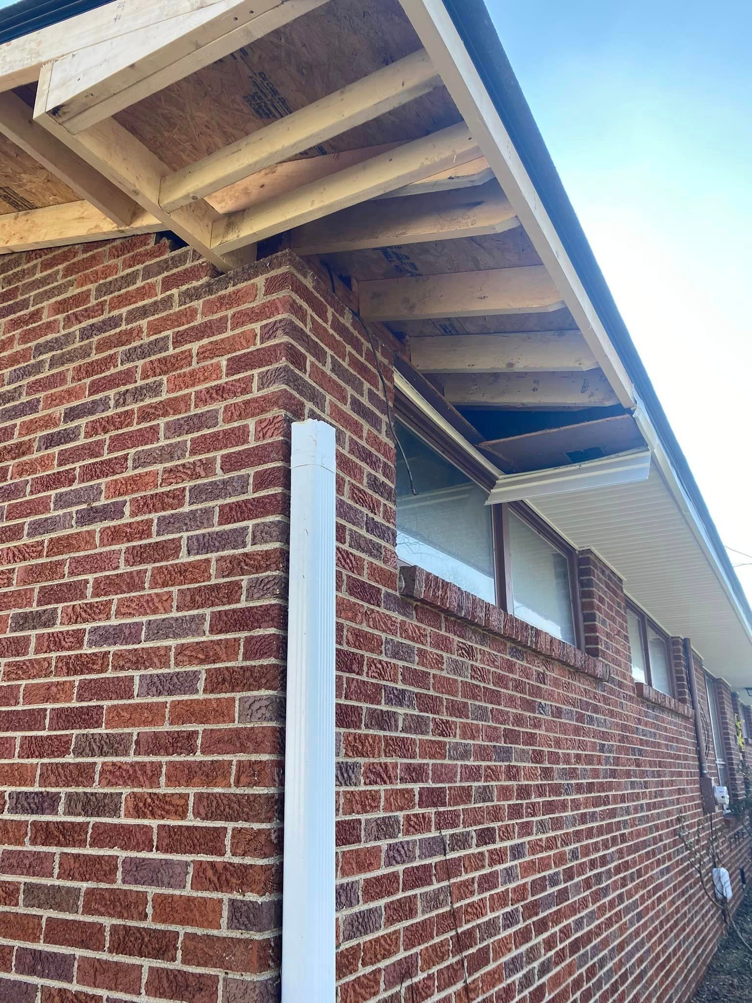 A brick building with a roof that is being built.