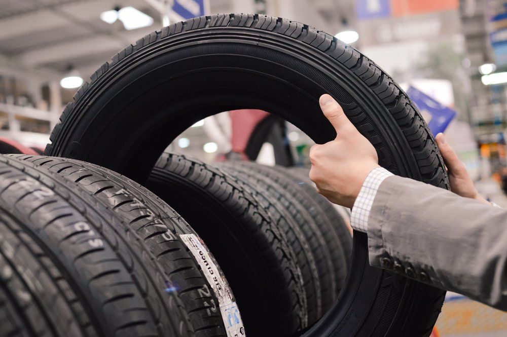 Man Choosing Tyre — Complete Tyre Management Services in Paget, QLD