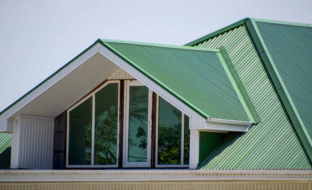 House With Green Steel Roof And Glass Windows