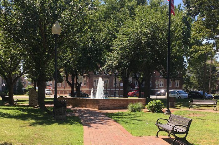 Fountain in a park near Regal Realty, Inc.