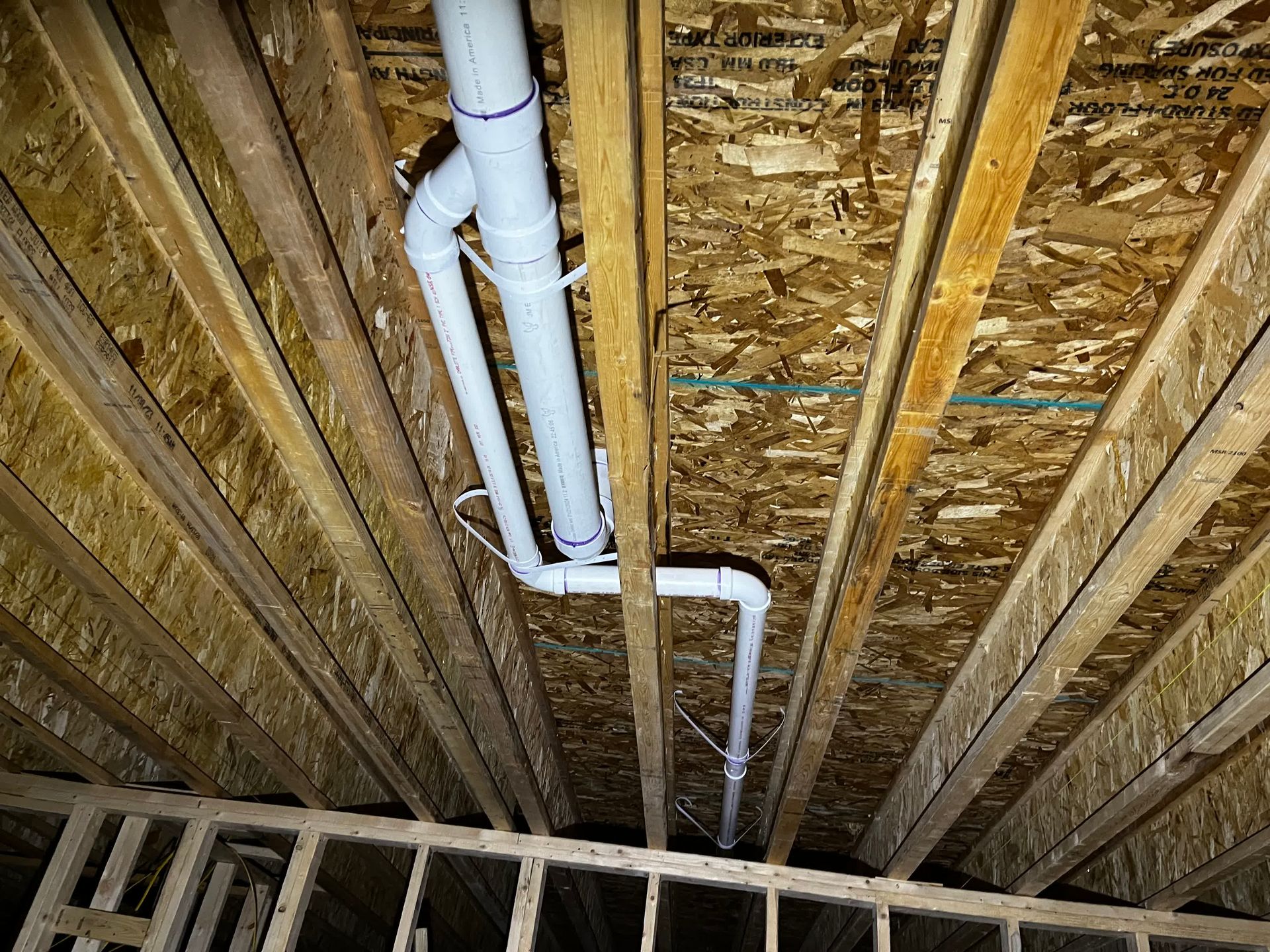 a man is fixing a sink pipe with water coming out of it