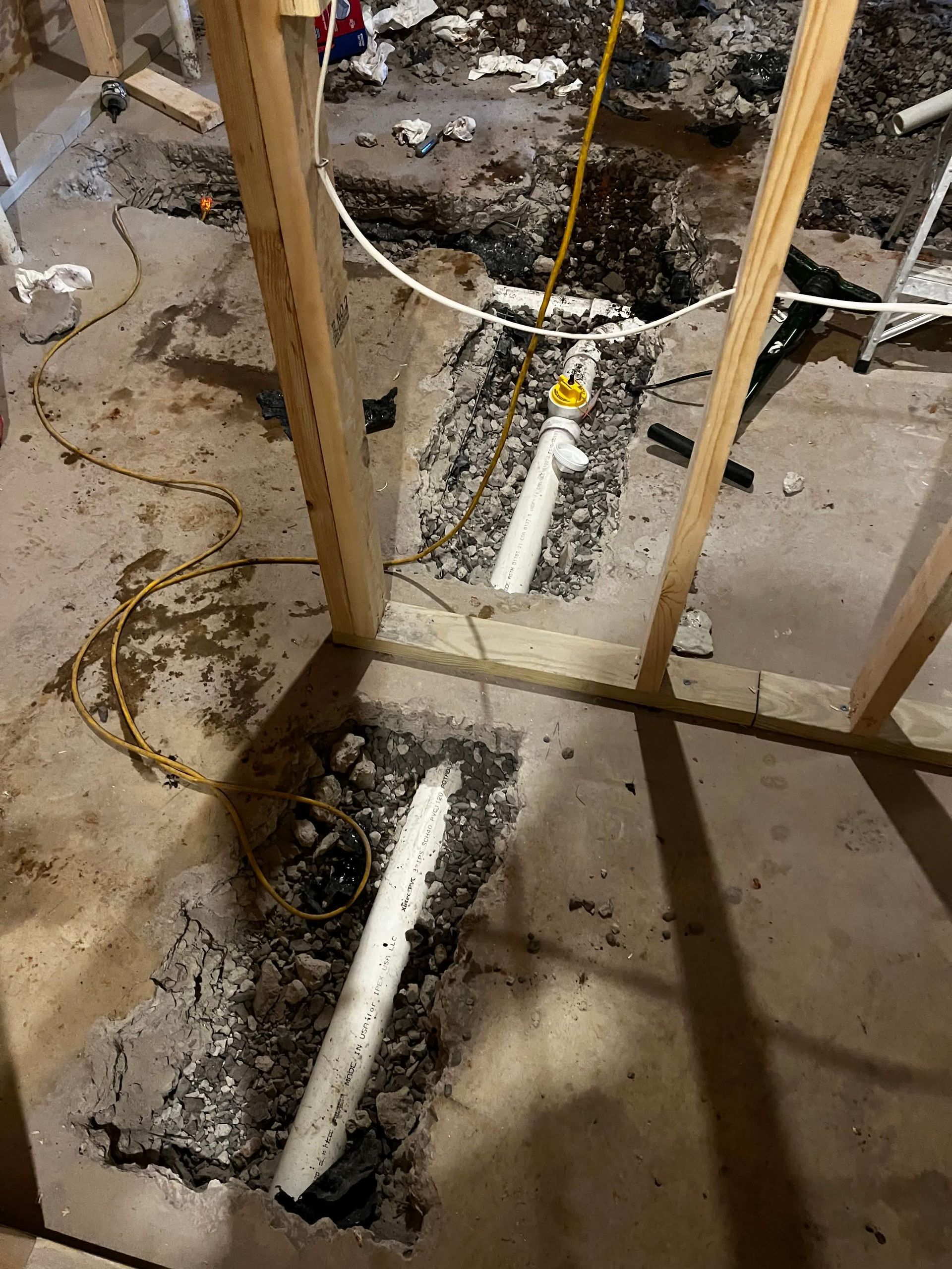 a man is fixing a sink pipe with water coming out of it