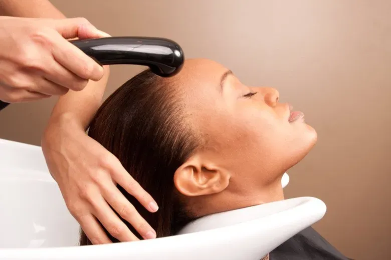 Woman Gets Her Hair Washed At A Salon — Silver Sping, MD — Montgomery Beauty School