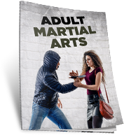 A man and a woman are standing next to each other in front of a brick wall.