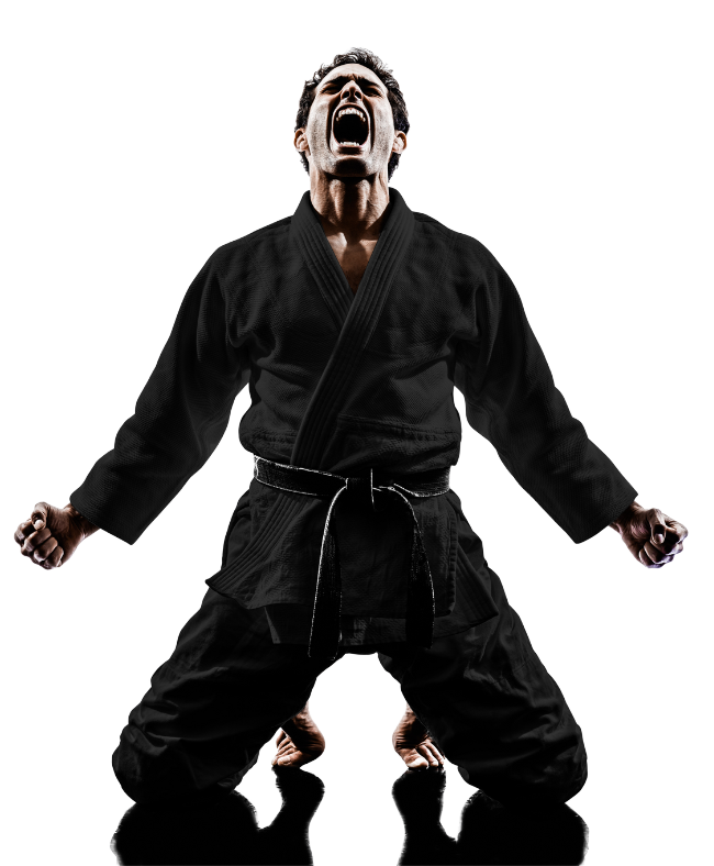 A man in a black karate uniform is kneeling down with his arms outstretched