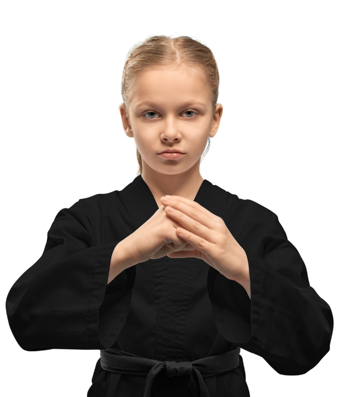 A young girl in a black karate uniform is making a karate pose.