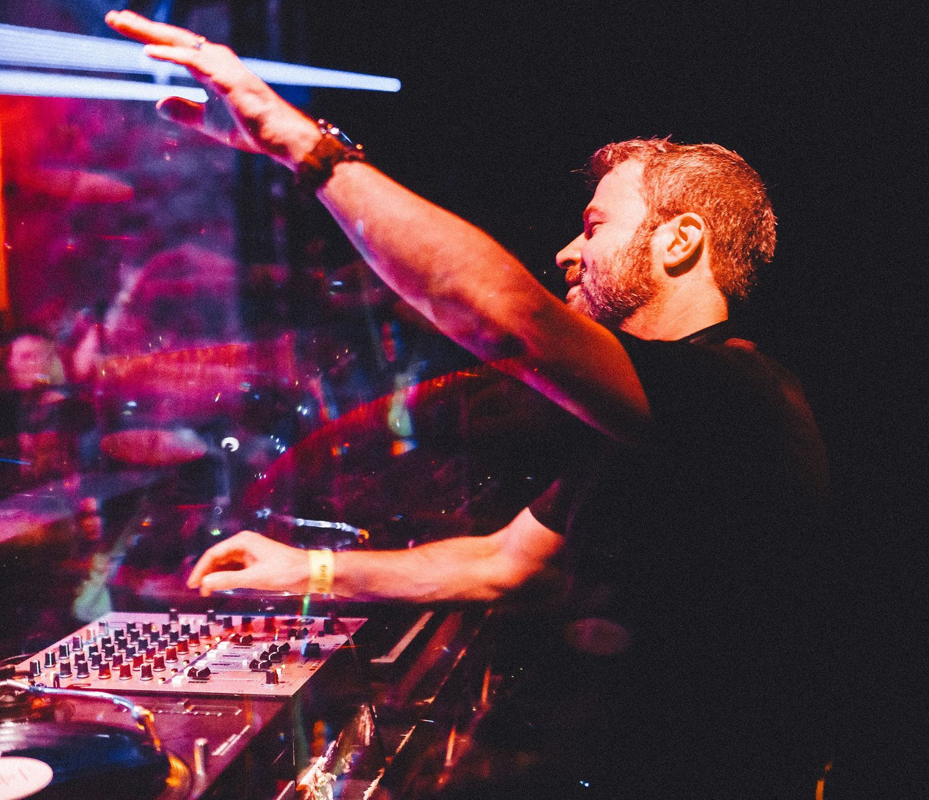 A man in a black shirt is playing a dj set