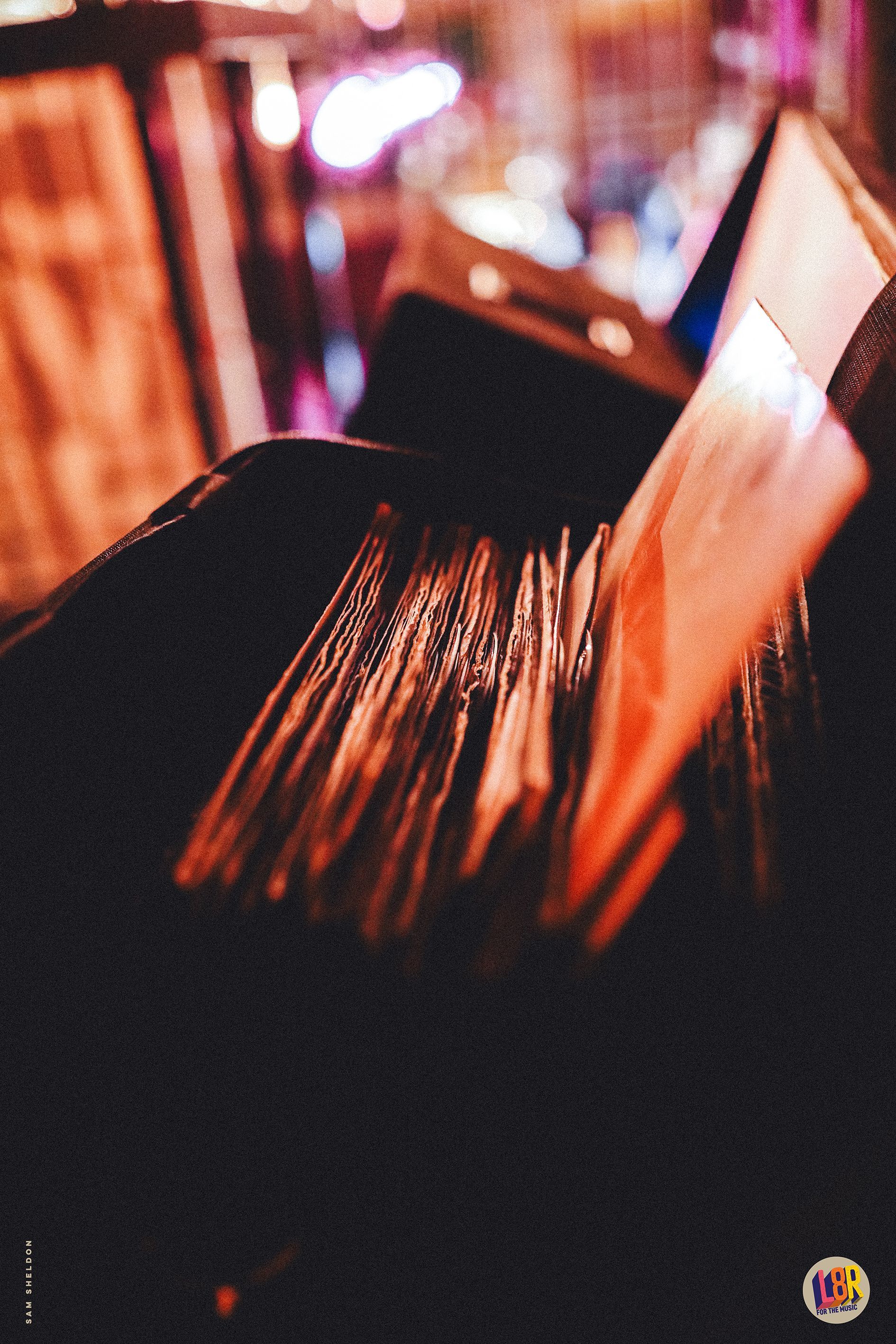 A person is holding a stack of records in their hands.