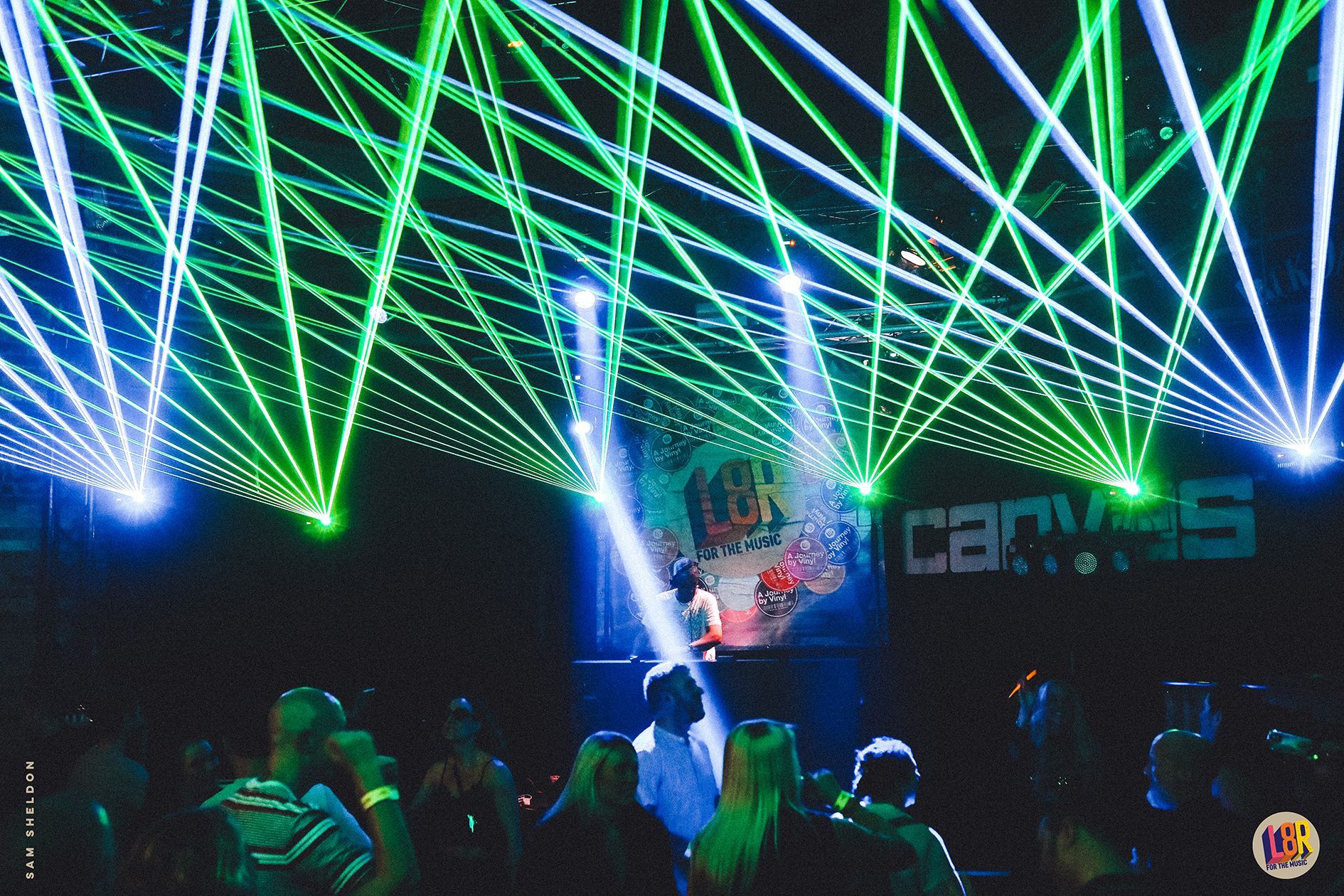 A group of people are standing in front of a stage with a sign that says cbn on it